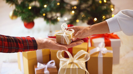 Image showing close up of couple hands with christmas gift box