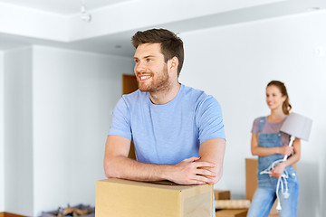 Image showing happy couple with boxes moving to new home