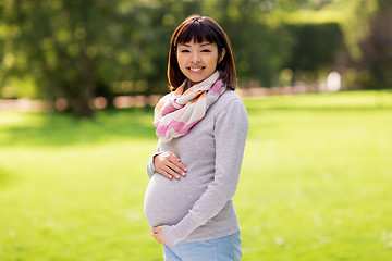 Image showing happy pregnant asian woman at park