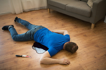 Image showing dead man body lying on floor at crime scene