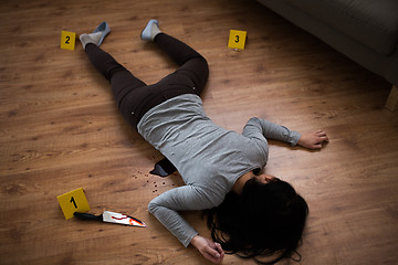 Image showing dead woman body lying on floor at crime scene