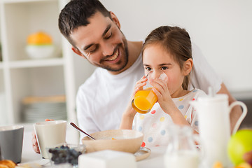 Image showing happy family having breakfast at home