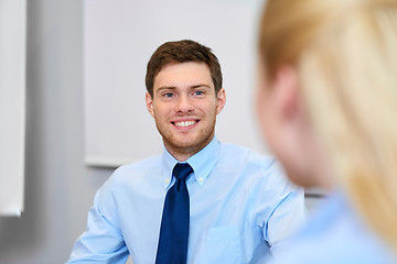 Image showing businessman talking to female colleague at office