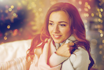 Image showing happy young woman with plaid at home for christmas