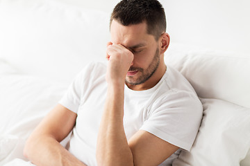 Image showing stressed man in bed at home