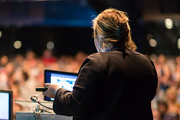 Image showing Female public speaker giving talk at Business Event.