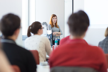 Image showing Woman giving presentation in lecture hall at university.