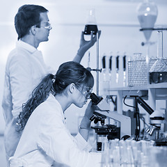 Image showing Health care professionals microscoping in scientific laboratory.