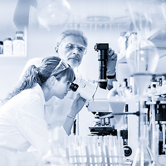 Image showing Health care researchers microscoping in scientific laboratory.