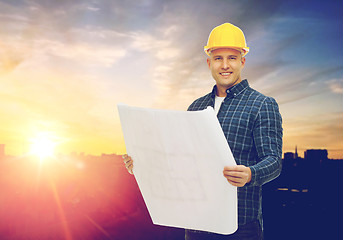 Image showing male builder in yellow hard hat with blueprint