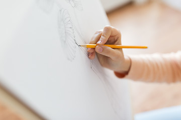 Image showing artist with pencil drawing picture at art studio