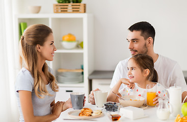 Image showing happy family having breakfast at home