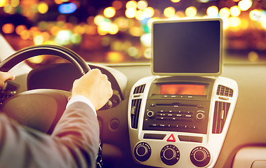 Image showing close up of young man with tablet pc driving car