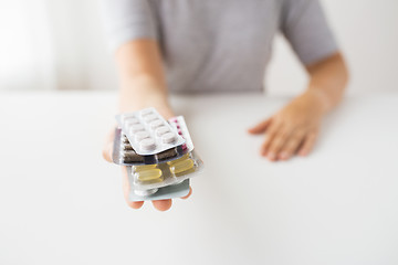 Image showing woman hands holding packs of pills