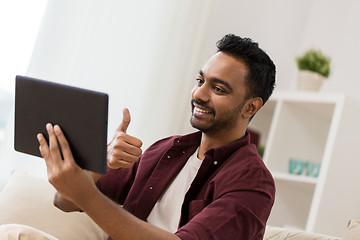 Image showing happy man with tablet pc having video chat at home