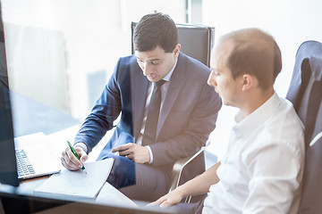 Image showing Business team brainstorming and dicussing business ideas at business meeting.