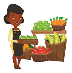 Image showing Supermarket worker with box full of apples.