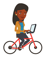 Image showing Woman riding bicycle and working on a laptop.