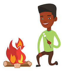 Image showing Man roasting marshmallow over campfire.