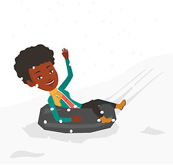 Image showing Woman sledding on snow rubber tube in mountains.