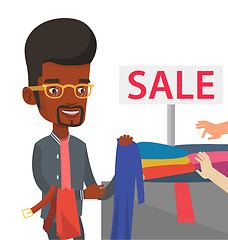 Image showing Young man choosing clothes in shop on sale.
