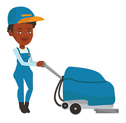 Image showing African worker cleaning store floor with machine.