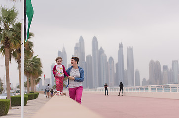 Image showing mother and cute little girl on the promenade