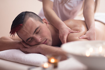 Image showing young man having a back massage