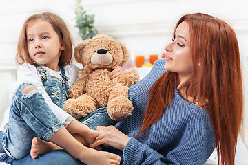 Image showing A little cute girl enjoying, playing and creating with toy with mother