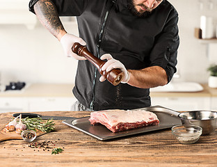 Image showing Man cooking meat steak on kitchen