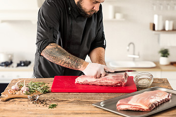 Image showing Man cooking meat steak on kitchen