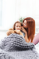 Image showing A little cute girl enjoying, playing and creating with toy with mother