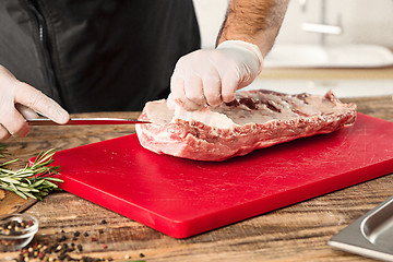 Image showing Man cooking meat steak on kitchen