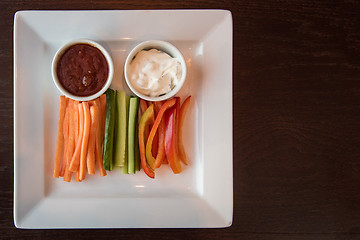 Image showing Fresh carrot cucumber pepper and two sauce