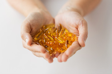 Image showing hands holding cod liver oil capsules