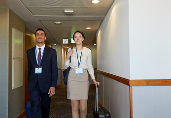 Image showing business team with travel bags at hotel corridor