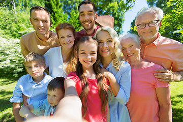Image showing happy family taking selfie in summer garden
