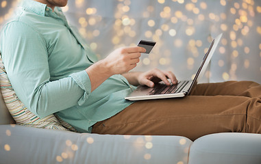 Image showing close up of man with laptop and credit card