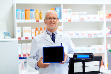 Image showing senior apothecary at pharmacy cash register