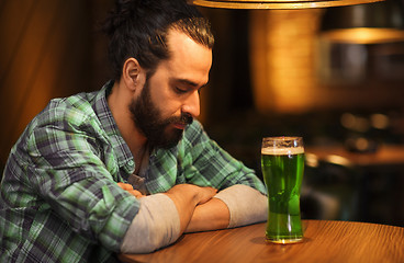 Image showing lonely man drinking green beer at bar or pub