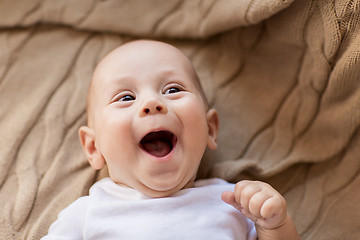 Image showing sweet little baby boy lying on knitted blanket