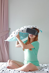 Image showing Young woman wearing virtual reality glasses at home.