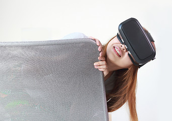 Image showing Young woman wearing virtual reality glasses at home.