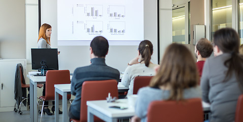 Image showing Woman giving presentation in lecture hall at university.