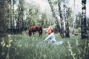 Image showing Beautiful Blonde Woman Resting In The Grass