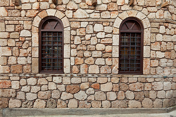 Image showing Two windows on old stone wall