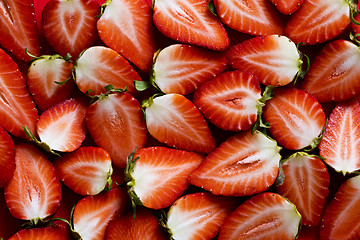 Image showing Fresh strawberries sliced into halves