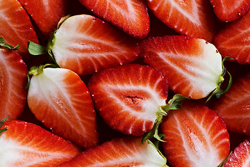 Image showing Fresh strawberries sliced into halves