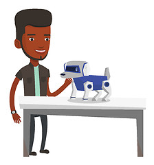 Image showing Happy young man playing with robotic dog.