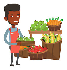 Image showing Supermarket worker with box full of apples.